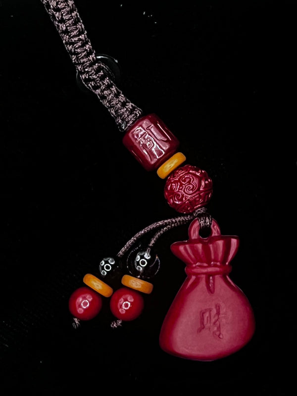 Decorative keychain with heart-shaped charm on a black background
